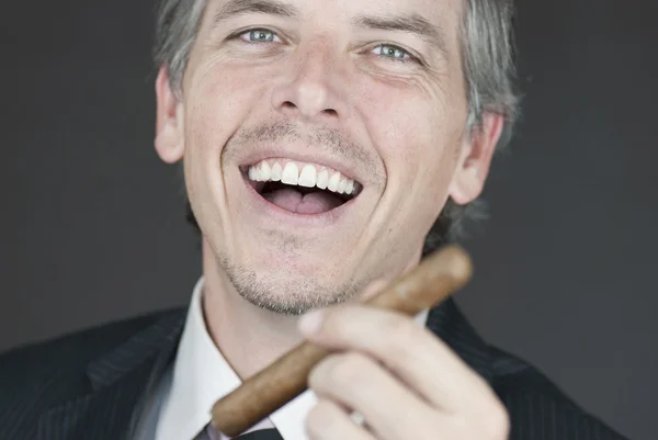 Smiling Businessman Holds Cigar — Stock Photo, Image