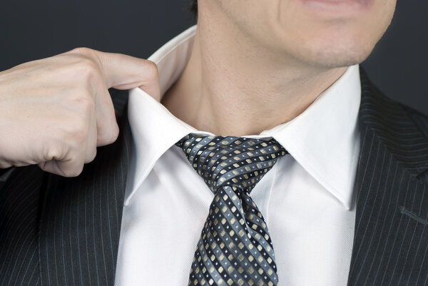 Stressed Businessman Pulls At Collar