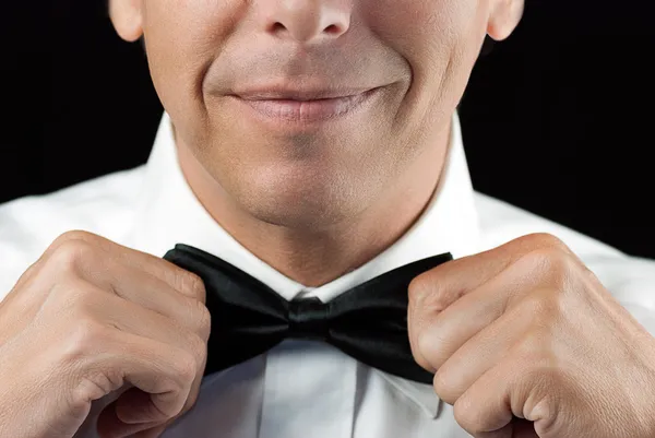 Man In Tux Straightens Bowtie, Two Hands — Stock Photo, Image