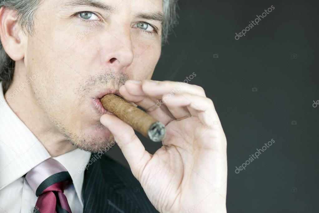 Businessman Smokes Cigar