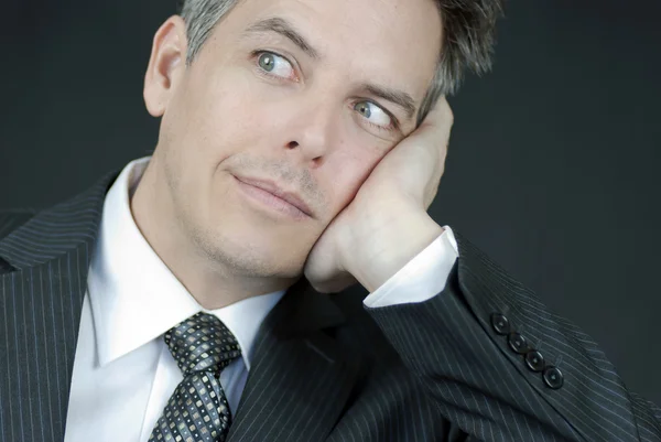 Businessman Looks At Camera While Ressting Head In Hand — Stock Photo, Image