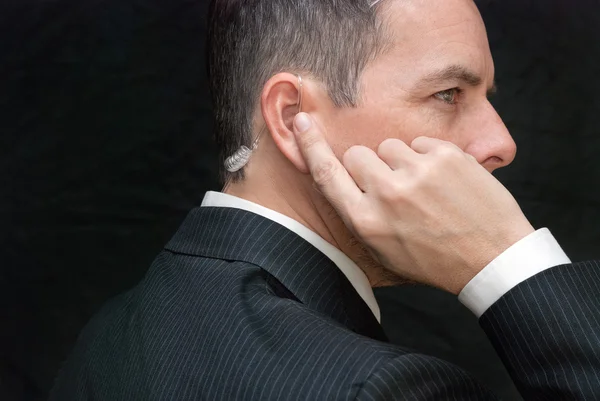 Secret Service Agent Listens To Earpiece, Side — Stock Photo, Image