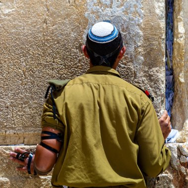 Jerusalem, Israel - May 09, 2022 - An Israeli soldier prays at the Western Wall