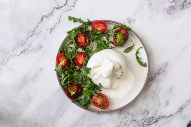 Taze roka ve kiraz domatesli Burrata peyniri.