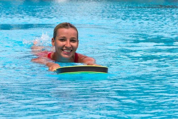 Swimmer during practice with board from polyfoam for swimming — Stock Photo, Image