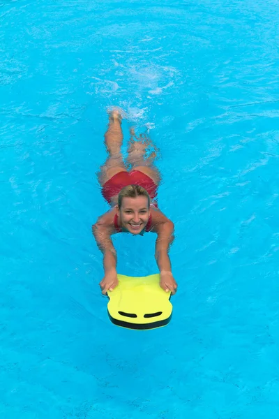 Swimmer during practice with board from polyfoam for swimming — Stock Photo, Image