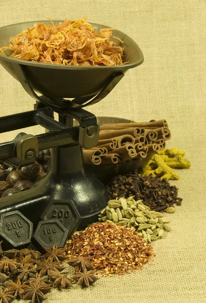 Spices and old weighing scales on hessian background — Stock Photo, Image