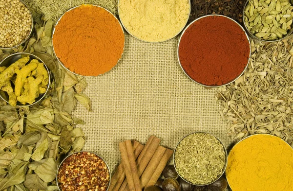 Herbs and spices on hessian background — Stock Photo, Image