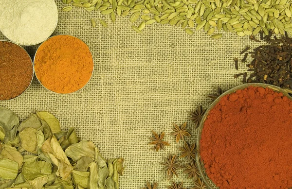 Herbs and spices on hessian background — Stock Photo, Image