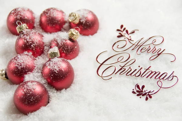 Merry Christmas Sign and Ornaments in Snow — Stock Photo, Image