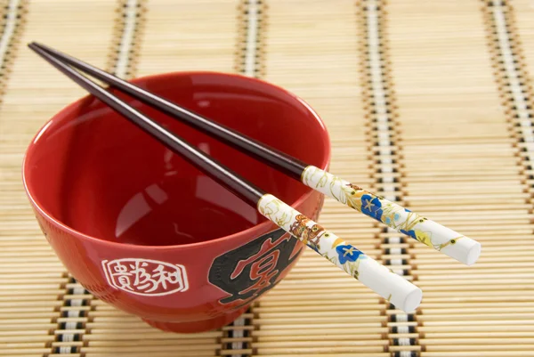 Chinese Rice Bowl and Snake Chopsticks on Rattan Mat. Chinese New Year — Stock Photo, Image