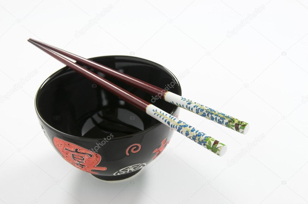 Chinese Rice Bowl and Decorated Chopsticks on White Background