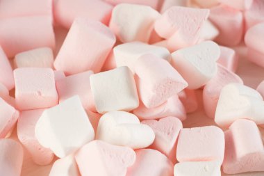 Sweet marshmallows on a pink pastel background. Childhood and birthday concept.