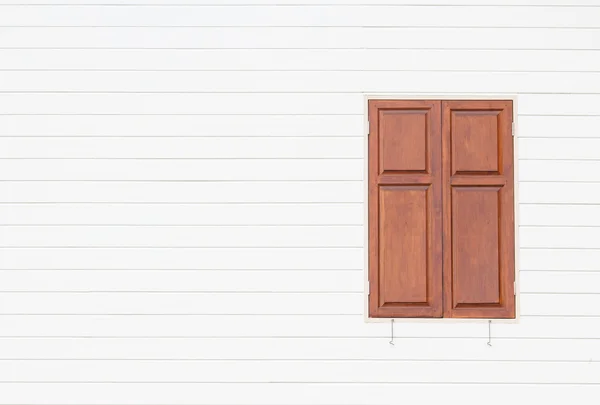 Brown window on white wooden wall background — Stock Photo, Image
