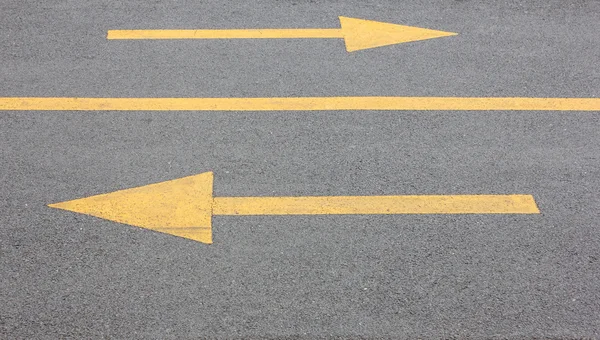 Yellow arrow right and left on asphalt steert road — Stock Photo, Image