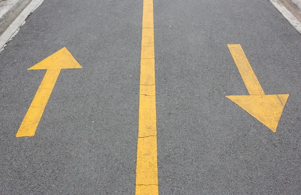 Yellow arrow up and down on asphalt street — Stock Photo, Image
