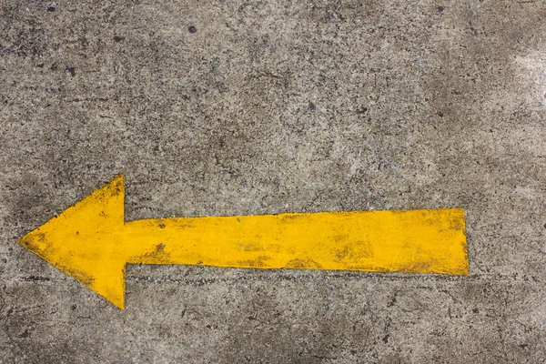 Yellow arrow left on asphalt street — Stock Photo, Image