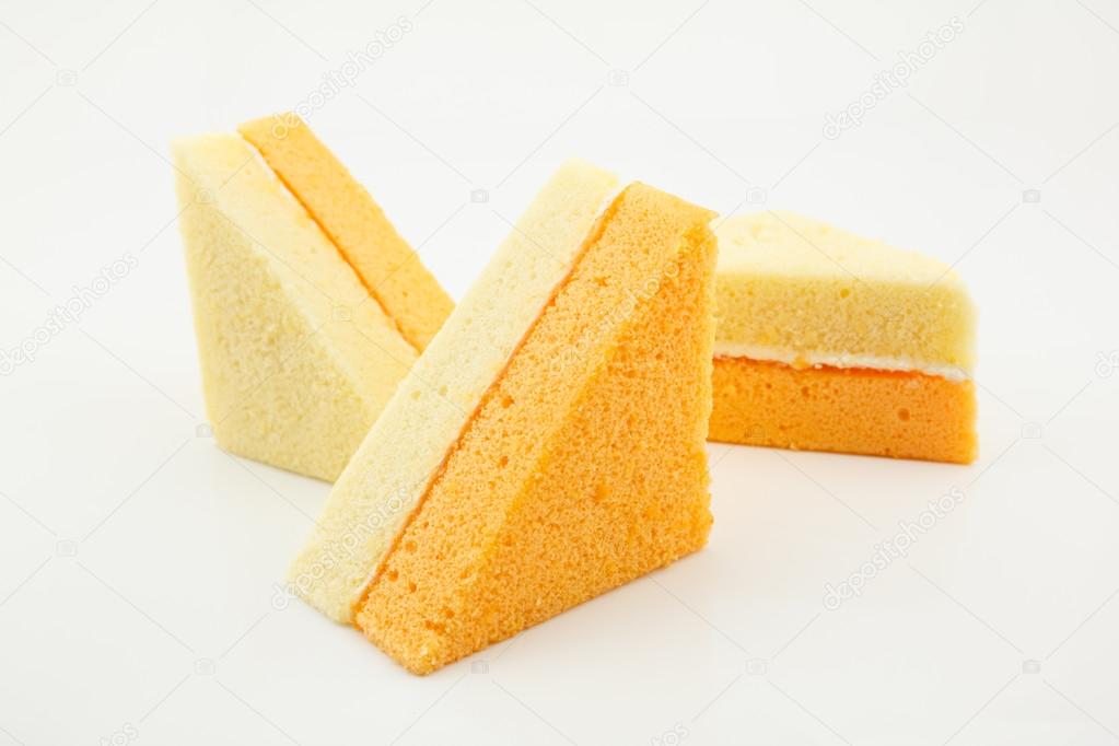 Vanilla and orange chiffon cake isolated on white background