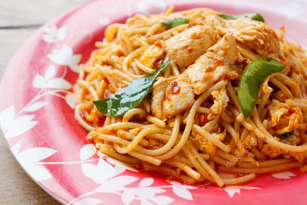 Stir Fried Spaghetti with Chicken in Chilli paste Stock Photo by