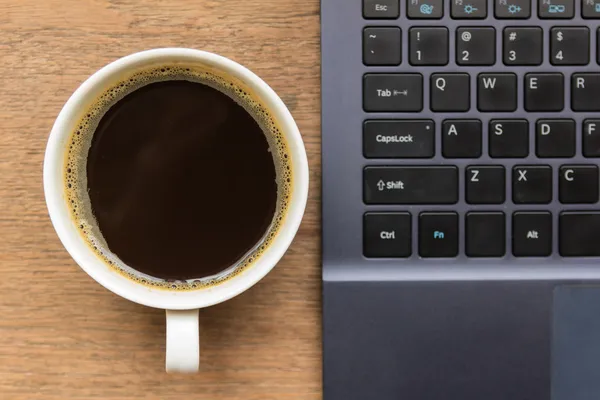 Top view of coffee cup , laptop on wooden table — Stock Photo, Image