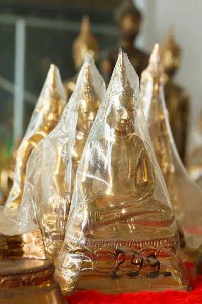 Buddha statues in plastic wrap — Stock Photo, Image