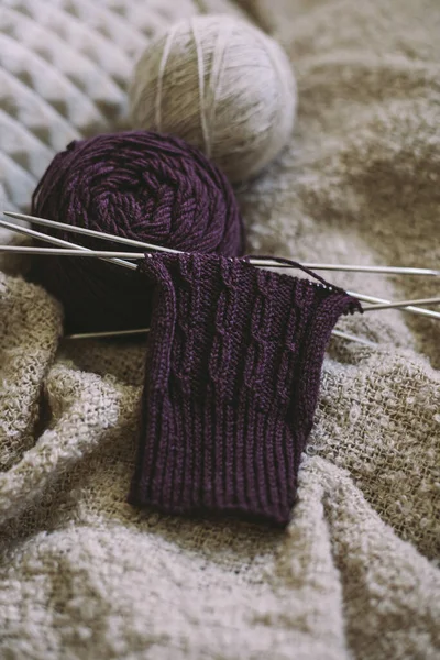 Hand knitting sock with needles and yarn balls.  Concept for handmade and hygge slow life.