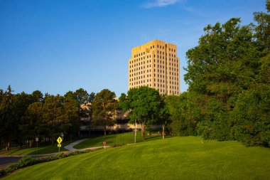 The North Dakota State Capitol, pictured here from the Capitol Grounds Native Prairie at Bismarck, is a 21-story Art Deco tower that is the tallest habitable building in the state.  
