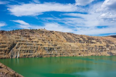 The Berkeley Pit, a former open pit copper mine located in Butte, Montana, is currently one of the largest Superfund sites that is filled with water that is heavily acidic.