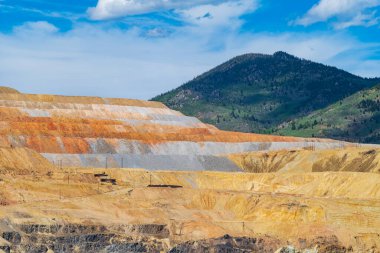The Berkeley Pit, a former open pit copper mine located in Butte, Montana, is currently one of the largest Superfund sites that is filled with water that is heavily acidic.