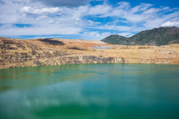 The Berkeley Pit, a former open pit copper mine located in Butte, Montana, is currently one of the largest Superfund sites that is filled with water that is heavily acidic.