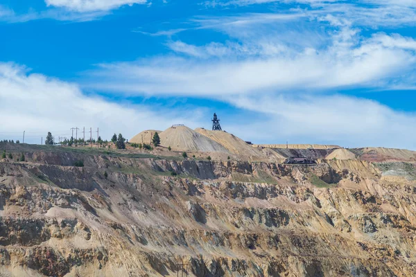 The Berkeley Pit, a former open pit copper mine located in Butte, Montana, is currently one of the largest Superfund sites that is filled with water that is heavily acidic.