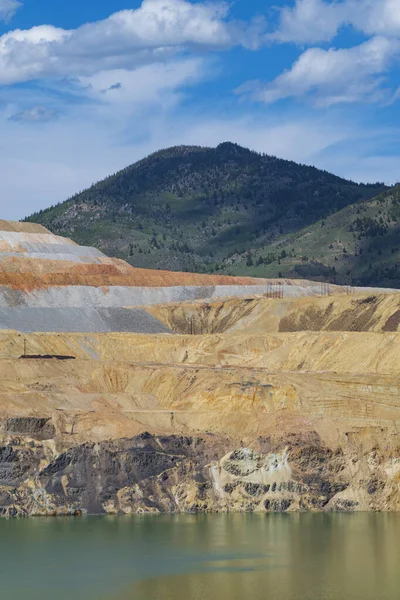 The Berkeley Pit, a former open pit copper mine located in Butte, Montana, is currently one of the largest Superfund sites that is filled with water that is heavily acidic.