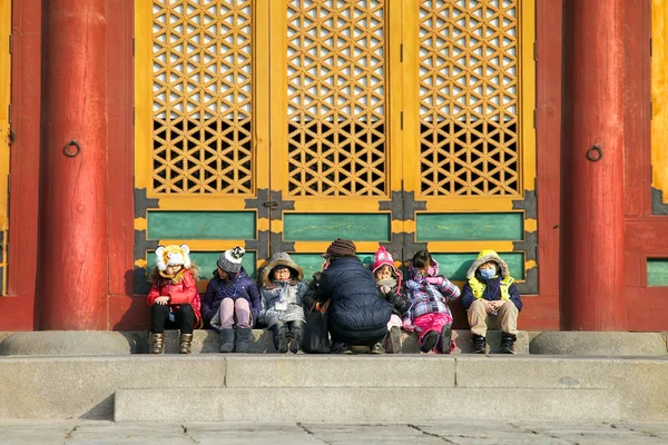I bambini sono seduti di fronte a una pausa per riscaldarsi — Foto Stock