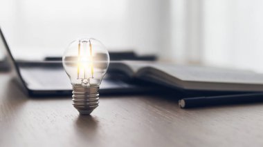 Parlak ışık ya da kitap ya da kitapla parlayan lamba. Ticari başarı fikri ve eğitim, öğrenim ve öğrenim kavramı. İş adamı ya da öğrenci bilgisi ilham ve bilişsel gelişim