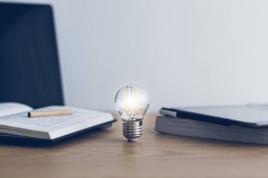 Bright light or glowing lamp with book or textbook. Business success idea and education, studying and learning concept. Businessman or student knowledge inspiration and cognition development