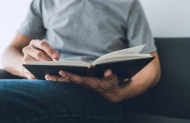 İşadamı kitap üzerinde çalışıyor ve okuyor. Öğrenci evde ders kitabı okuyup öğreniyor. Eğitim bilgi geliştirme ve bilişsel öğrenme konusunda başarı fikri