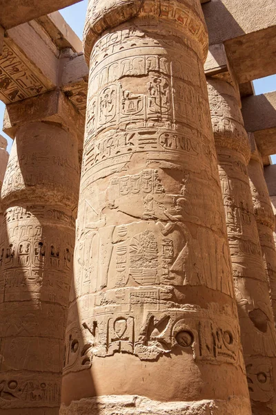 Massive columns after reconstruction inside beautiful Egyptian temple in Luxor with hieroglyphics, and ancient symbols. Karnak temple.