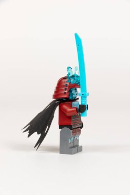 Yekaterinburg 'da. - Rusya. 04.08.2021. Zırhlı bir kılıç ve beyaz bir arka planda lego ninjalarından bir kask taşıyan kahraman buz savaşçısı. Yakın plan. seçici odak