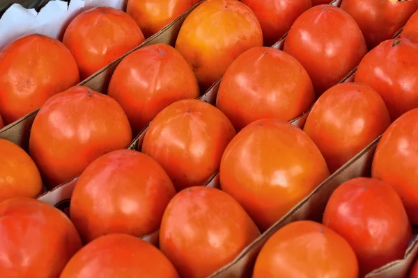 Persimmon in a box — Stock Photo, Image