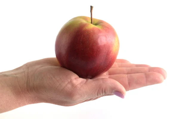 Apple in feminine hand isolated on white background — Zdjęcie stockowe