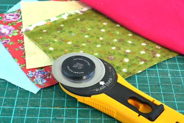 Roterende mes en stukken van doek voor lappendeken — Stockfoto