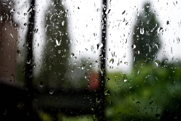 raindrops on the window pane with blurred background