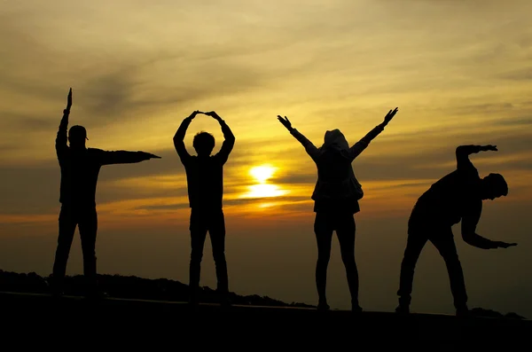 Liebe Silhouette von vier Personen auf Sonnenaufgang Hintergrund — Stockfoto