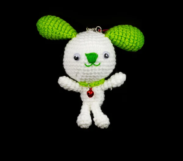 Handmade crochet white rabbit with green ear doll on black backg — Stok fotoğraf