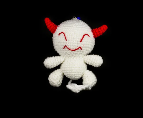 Handmade crochet white devil with red ear doll on black backgrou — Stock Photo, Image