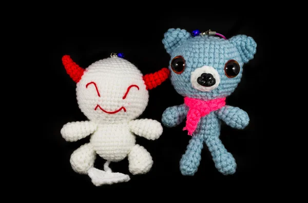 Handmade crochet white devil and dog doll on black background — Stock Photo, Image
