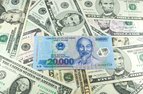 Twenty thousand vietnamese VND done on many dollars background — Stock Photo, Image