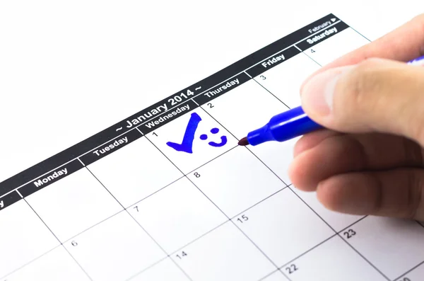 Cheque azul con sonrisa. Marca en el calendario el 1 de enero de 2014 —  Fotos de Stock