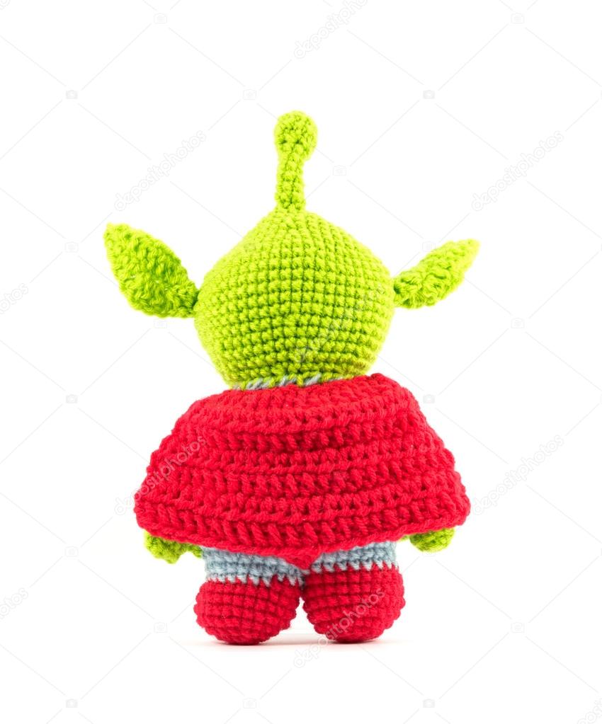 Handmade crochet green alien three eyes super hero doll on white