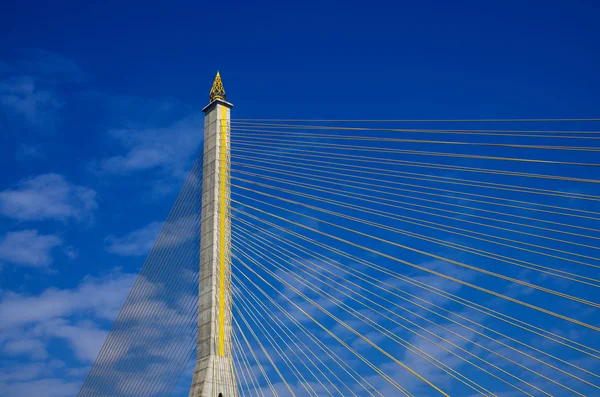 Fragment of a cable stayed bridge on blue the sky background. — Stock Photo, Image